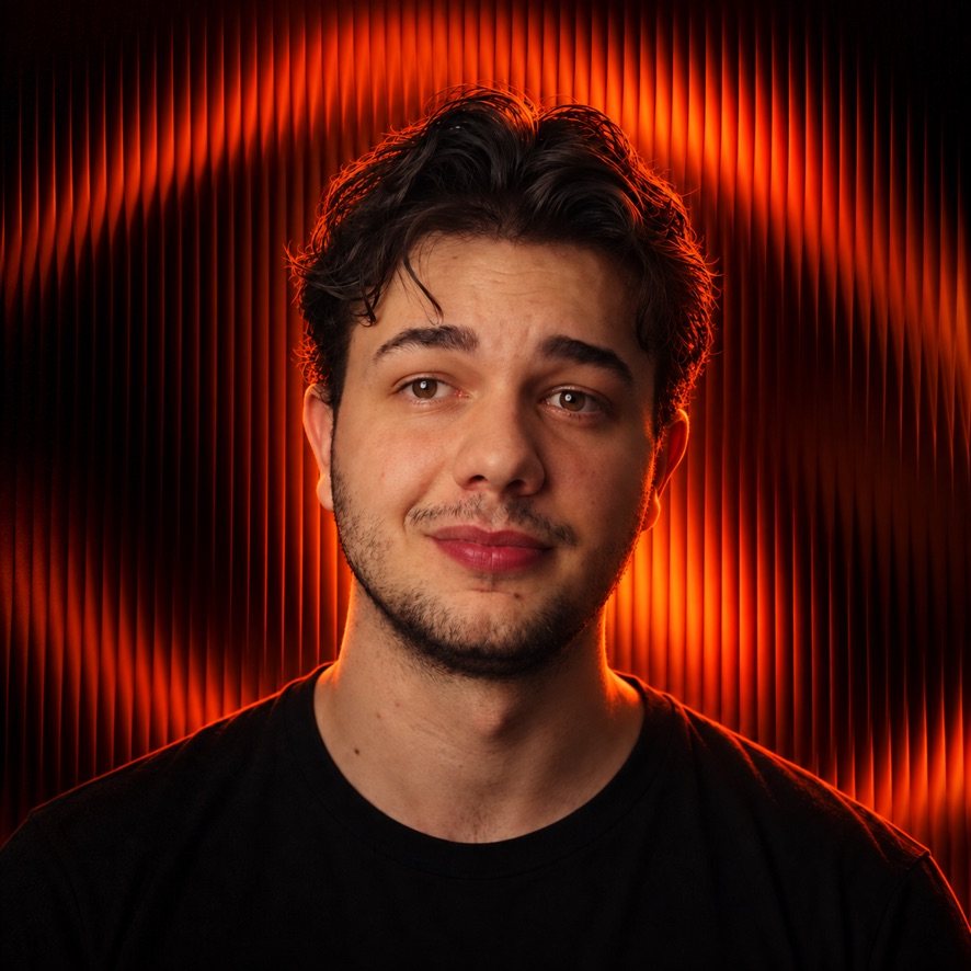 Portrait of Noah Spirig in front of orange-lit slats